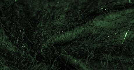 Emerald green silk fabric with sequins and yarns on the surface of the fabric. This abstract...