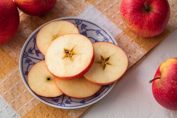 A sliced red apple on a plate. Diet eating.