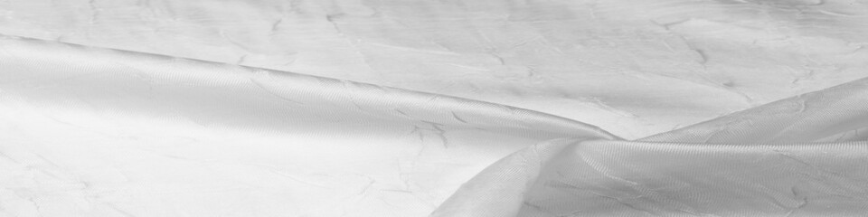 Silk fabric White. Dented and smoothed with traces of stripes. Texture background. Matte wedding satin fabric. These sophisticated lightweight stretch satin textiles create a stylish look.