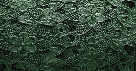 Lace fabric in green. Pure cotton lace with floral pattern embellished with embroidery. Light Transparency. Textured. Background. Pattern