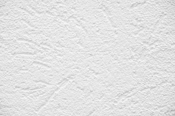 White plaster on the building. Plaster is a building material used for protective or decorative coating of walls and ceilings. After drying off from calcium carbonate, it turns white