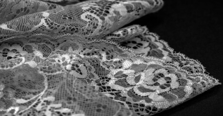 Black lace. Vintage floral background. Lace is an openwork fabric obtained by crossing the threads that form motives connected by the base