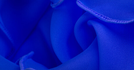 Blue silk organza with wavy piping. Border around the edge of the fabric. Abstract background....