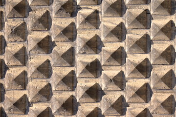 old grey concrete wall, pyramid, pyramidal shape