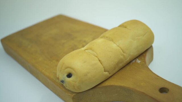footage of bread and puff rice over the wooden board with white background. That footage perfect for food pamphlet, product poster, product promotion and ads.