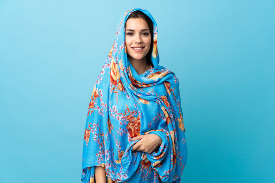 Young Moroccan woman with traditional costume isolated on blue background