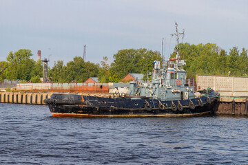 Old marine support nautical vessel is moored at the port in Kronstadt, Russia