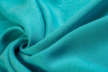turquoise fabric, twill. Thin fabric with diagonal weaving of threads. From Latin and French, the name of the material is transla Texture, background