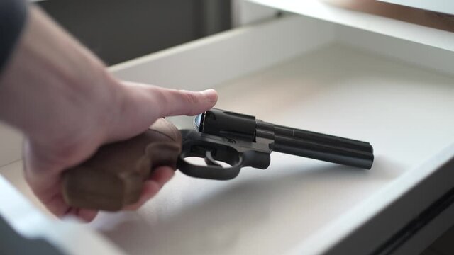 Taking a Gun From a Drawer Closeup Shot Revolver Pistol