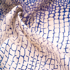silk fabric styled as python skin, navy blue pattern, African theme. Texture. Background.
