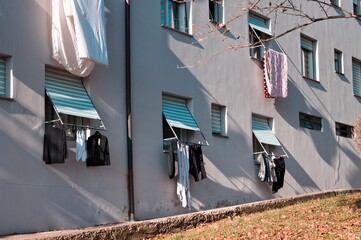 Clothes, towels and bed sheets hanging out of the window to dry (Pesaro, Italy, Europe) - 476769165