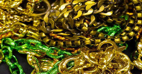 Anodized metal chain, jewelry. The chain is a sequential assembly of connected parts that have a common rope character, since it is flexible and curved.