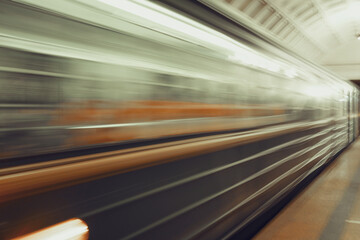 Fototapeta na wymiar A greased train at high speed rushing past at a metro station