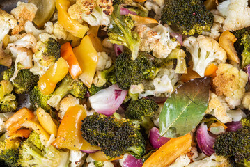 Baked vegetables with broccoli and cauliflower, top view, close-up