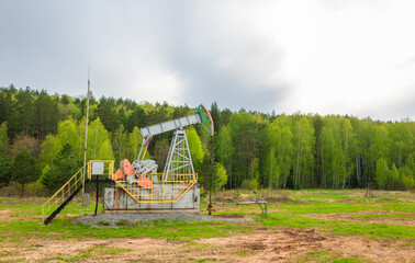 Fototapeta na wymiar Oil deposit. Pump jacks, which are known as nodding donkeys. Crude oil is found in all reservoirs formed in the earth's crust from the remains of once living creatures