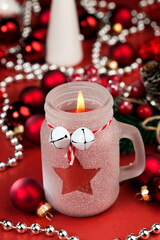 christmas candle in a glass jar and other decorations
