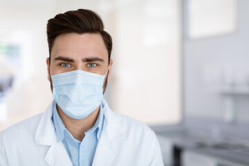 Fototapeta na wymiar Closeup portrait of male doctor in protective face mask