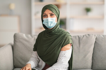 Vaccinated Muslim Lady Showing Arm With Plaster Bandage At Home