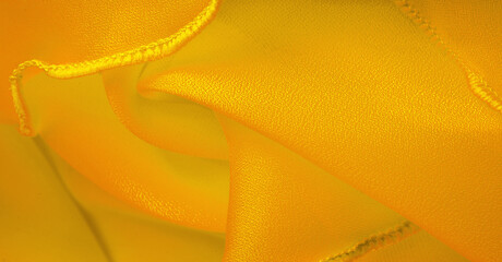 Yellow silk organza with wavy piping. Border around the edge of the fabric. Abstract background....