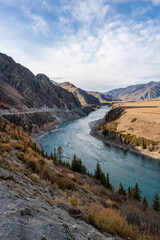 Landscape with a turquoise river among the mountains along the road in Altai.