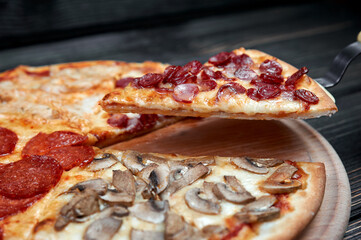 Hot big pepperoni pizza tasty pizza composition with melting cheese bacon tomatoes