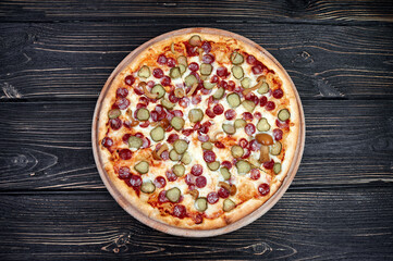 Hot big pepperoni pizza tasty pizza composition with melting cheese bacon tomatoes