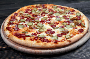 Hot big pepperoni pizza tasty pizza composition with melting cheese bacon tomatoes