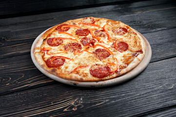 Hot pizza with Pepperoni Sausage on a dark background