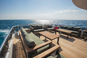Table and chairs on stern deck of a luxury motor yacht