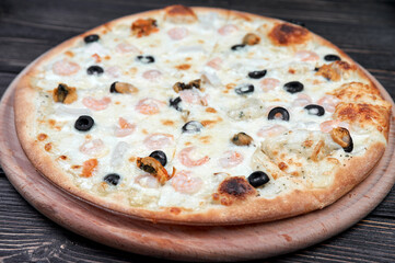 Seafood Italian pizza with shrimp,squid, mussels, fresh herbs and mozzarella