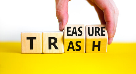 Trash to treasure symbol. Businessman turns cubes and changes the word trash to treasure. Beautiful...