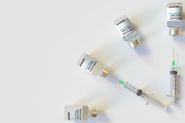 Clock face made with pertussis vaccine vials and syringes. Vaccination time concept. Conceptual medical 3D rendering