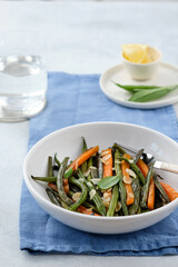 Green beans with carrots cooked with olive oil and sage. Healthy food.