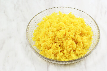 Cooked Yellow Rice in a Bowl, a Portion of Cooked Yellow Rice in Ceramic Plate