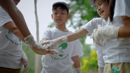 Children volunteering for community activities are hands holding together to join forces before starting outdoor volunteer activities.concept successful team
