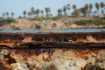 Remains of a rusted handrails on a waterfront on a background of sea. Metal corrosion due to frequent exposure to sea water close-up.