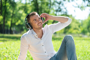 Man in the park listens to music