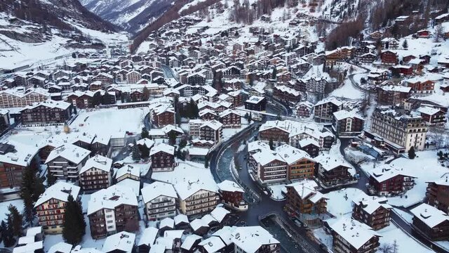 Aerial drone footage of the snow covered Zermatt village in Canton Valais in winter in Switzerland