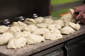 Fototapeta na wymiar Dough. Fresh raw dough preparation. Preparing pizza dough on a professional culinary worktop. Pizzeria
