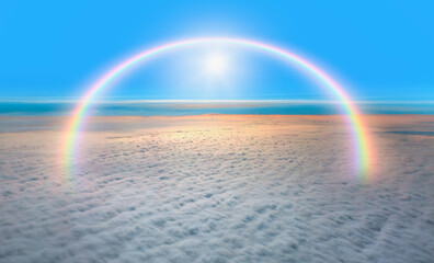 The sun shines on the sky with amazing rainbow over the clouds. Fantastic background