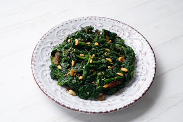 Spinach with pine nuts and raisins. Traditional Catalan recipe. Typical dish of Barcelona.