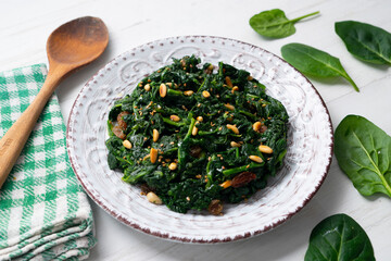 Spinach with pine nuts and raisins. Traditional Catalan recipe. Typical dish of Barcelona.