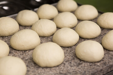Dough. Fresh raw dough preparation. Preparing pizza dough on a professional culinary worktop. Pizzeria