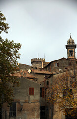 View from below of the buildings of the old town of Bracciano, against a cloudy sky, Bracciano, Lazio, Italy