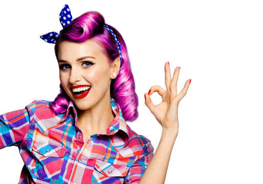 Pin up girl. Portrait photo of excited happy smiling purple hair woman showing ok okay hand sign gesture. Retro and vintage concept. Isolated over white background. Female model posing at studio.