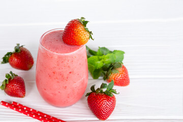 Strawberry yogurt fruit juice smoothie pink colorful fruit juice milkshake blend beverage healthy high protein the taste yummy In glass drink episode morning on white wood background.