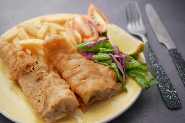 Fish fillet , chips and potato mash on table 