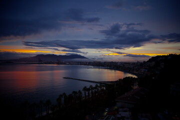 Sunset in Malaga beach. Low clouds. 