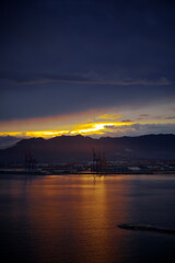 Sunset in Malaga beach. Low clouds. 