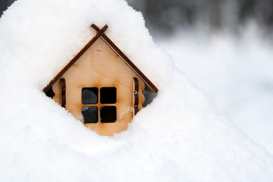 Toy Wooden House Deeply Covered With Snow In Winter Evening